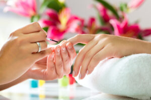 photo of a lady's hands who is receiving a manicure