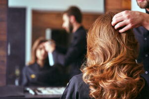 photo of pretty woman getting her hair cut and styled